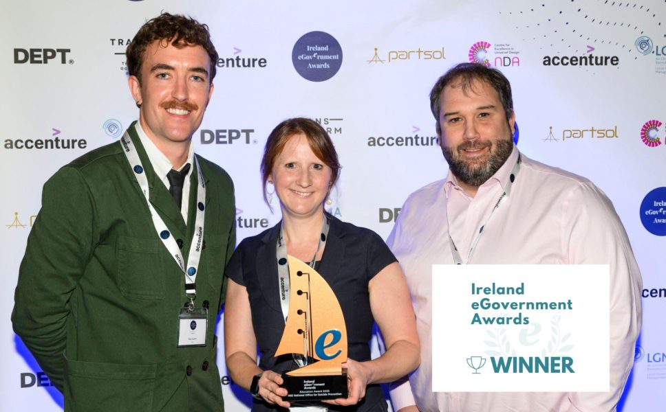 Image from the 2025 Ireland eGovernment Awards on Thursday 18th September 2025. Pictured left to right are: Dan Eames, Senior Digital Design Advisor at the National Disability Authority (NDA); Sarah Woods, Policy Lead at Department of Health and HSE National Office for Suicide Prevention; Gavin Woods, Managing Director at Aurion Learning. The Ireland eGovernement Awards logo and 'WINNER' badge are present in white in the bottom right hand corner.